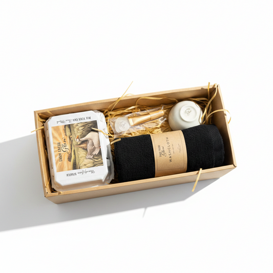 Gift set with black towel, a quail egg carton, bowl, and spatula in a box on a white background